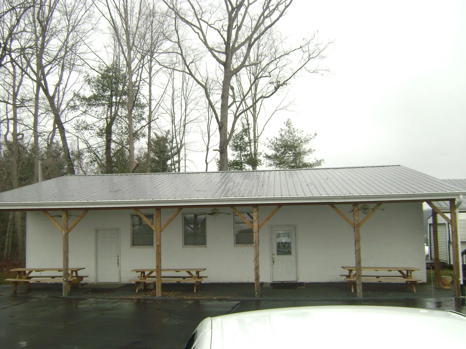 Gray metal roof over a block building with a timber post porch in Rio